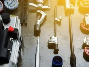 HVAC emergency repair tools and gauges on workbench, ready for urgent heating and cooling service