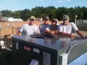 HVAC crew installing rooftop unit at Tommy’s Tavern with completed commercial HVAC system.